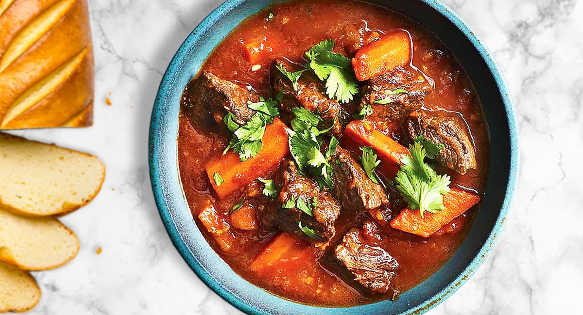 A bowl of Vietnamese Beef Stew with fresh herbs and spices